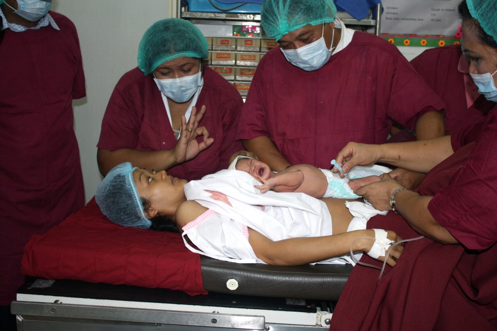 Doctors educating mother about vaccination for newborn babies (the Philippines, 2016) 