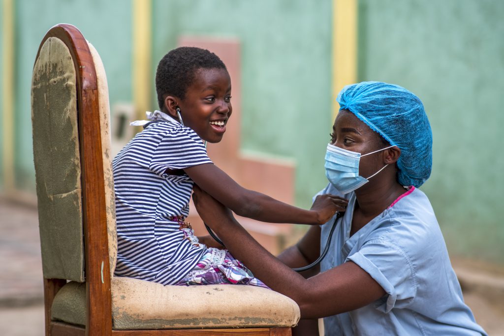 A closeup shot of a boy and a doctor wearing sanitary mask