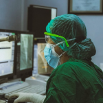 a doctor sitting in front of a computer