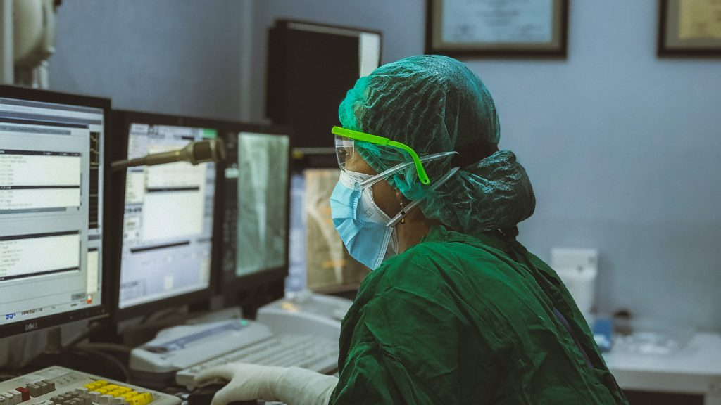 a doctor sitting in front of a computer