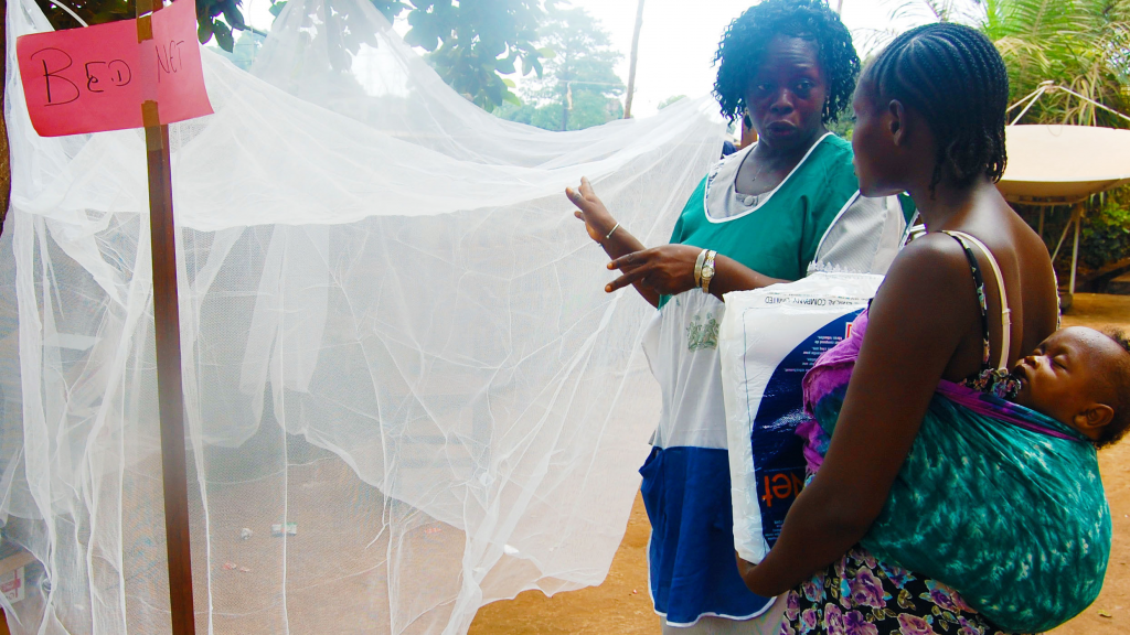 An image depicting a female holding a baby, accompanied by another woman standing nearby.